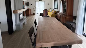 A modern kitchen with a wooden dining table, black chairs, and pendant lights. - Near Le Touquet, renovated villa for a relaxing break with family or friends. (Cucq)