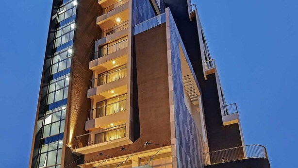 A modern hotel with a prominent entrance, multiple floors, and a well-lit facade. - Clarion Hotel Khayal Kochi, Infopark (Kanayannur)