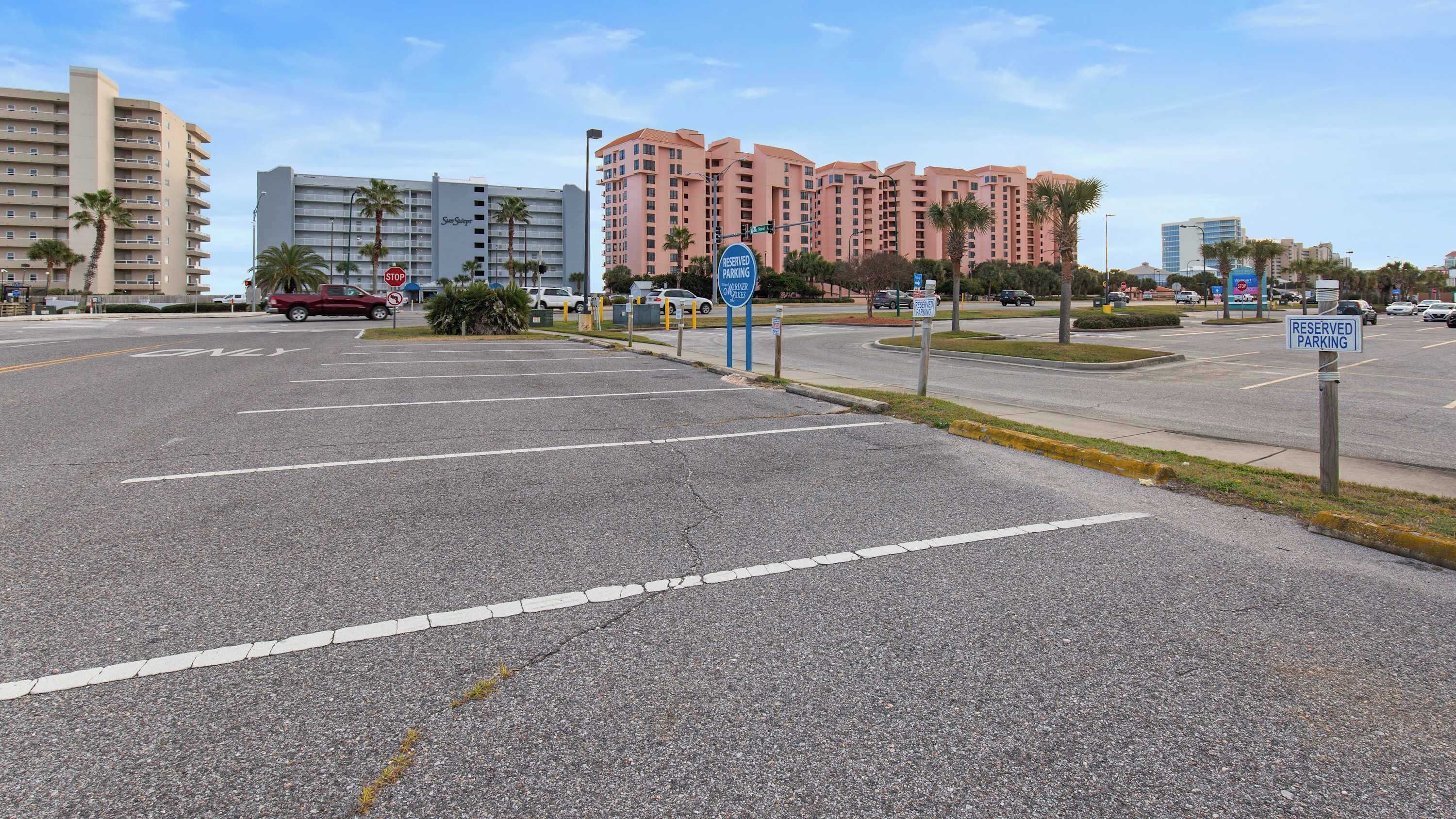A parking area with multiple signs indicating reserved parking spaces.