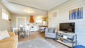 A compact living space with a kitchen, dining area, and a seating area with a TV and entertainment unit. - Walk to Lake & Trails: Cape Fair Retreat w/ Grill! (Cape Fair)