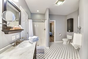 A modern bathroom with a large sink, a bathtub, a shower, and a toilet. - Mountain Views & Fire Pit: Sandgate Getaway (Arlington)