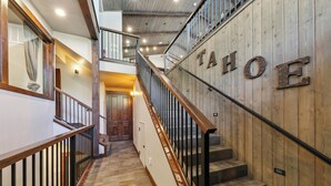 A staircase with wooden railings and a sign that reads "TAHOE". - Mountain Majesty: Lake Views, 10-Bedroom, Pool (South Lake Tahoe)