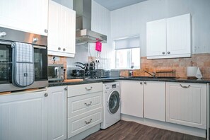 Een magnetron, een oven, een kookplaat, een vaatwasser