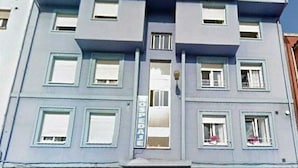 A building with a sign reading "Puente Azul" and a smaller sign below it that says "HOTEL".