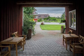 A wooden interior with a brick pathway leading outside. - Klaara-Manni Holiday Center (Randivälja)