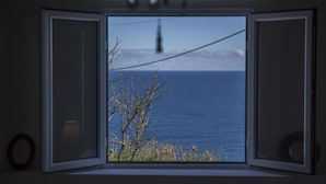 An open window with a view of the sea and a clear sky. - Water from Alto Main House (Água de Alto)