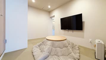 Deluxe Apartment | Living area | 55-inch Smart TV with digital channels