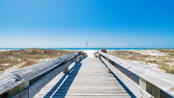 A wooden boardwalk leading to a beach with clear skies. - Beachfront 3BR! New to the Market! Just Renovated! (Orange Beach)