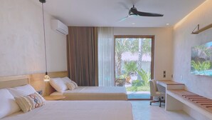 A hotel room with two beds, a desk, a ceiling fan, and a large window with a view of greenery. - Bidmont Villa Spa (Puerto Escondido)