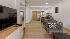 A modern apartment with a living area, kitchenette, and dining space. - Bran new condo with pool access (Bavaro)
