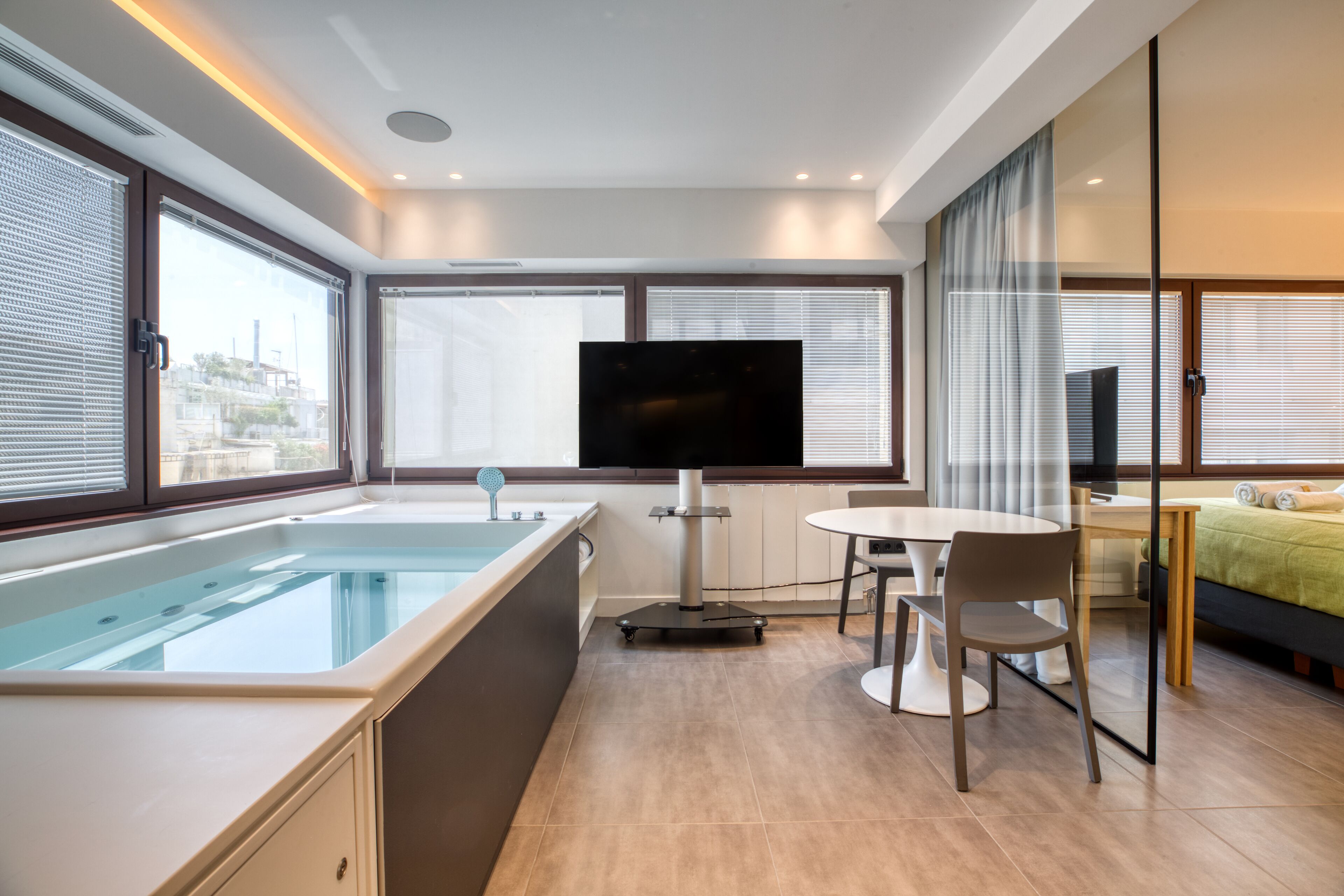 Queen Suite Elea | Living area | 55-inch plasma TV with cable channels, smart speakers