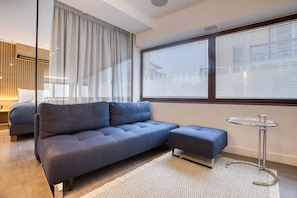 Queen Suite Danfe | Living area | 55-inch plasma TV with cable channels, smart speakers