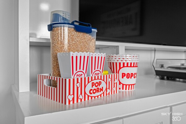 A snack bar setup with popcorn containers and popcorn boxes.