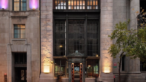 A large, historic building with a prominent entrance labeled "National Trust Company." - SonoLux (Montréal)