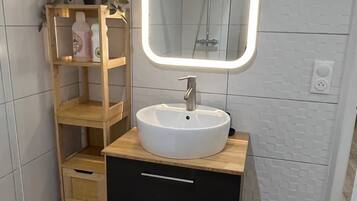 Een haardroger, handdoeken, zeep, toiletpapier