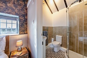 A bathroom with a shower, toilet, and sink. - Dale View Cottages  (Whitby)