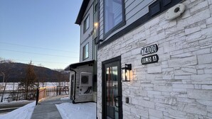 A two-story building with a stone facade and a clear sky. - Gateway to Alaska Wonders A308 (Juneau)