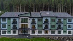 A multi-story building with a symmetrical facade, large windows, and balconies. - Juneau Jewel: Luxury & Relaxation A307 (Juneau)