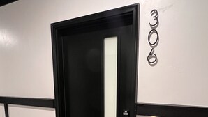 A black door with a white panel, a number '300' on the wall, and a striped doormat. - Luxury Views, Affordable Stay A306 (Juneau)