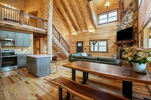 A spacious cabin interior with a kitchen, dining area, and living room. - Frog Hill | Hocking Hills, EV Charger, Hot Tub (Logan)