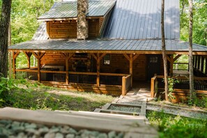 A wooden cabin with a porch and a stone chimney. - Frog Hill | Hocking Hills, EV Charger, Hot Tub (Logan)
