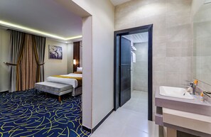 Relax in this stylish room with a large bed, bedside table, and bathroom amenities.
