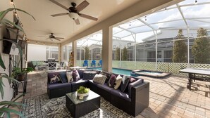 Patio esterno con piscina, zona salotto e ventilatori a soffitto.