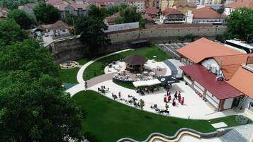 An outdoor plaza with a central gazebo, surrounded by seating areas and a fountain.