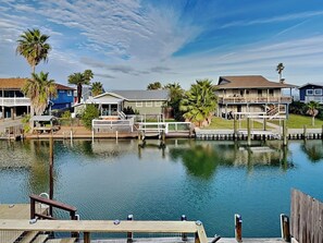 Waterfront homes with attached docks and balconies, surrounded by lush greenery and offering serene views.