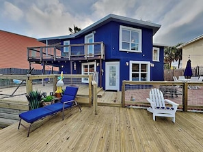 A two-story house with a deck, a balcony, and a small garden area. - Siesta Keys by Miss Kitty’s (Rockport)