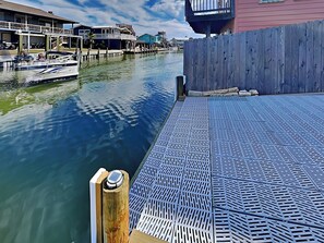 Guests can enjoy a waterfront view from the dock, surrounded by moored boats and a secure railing.