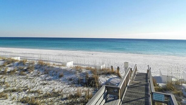 A wooden boardwalk leading to a beach with clear skies. - Emerald Port Of Call by Southern Vacation Rentals (Miramar Beach)