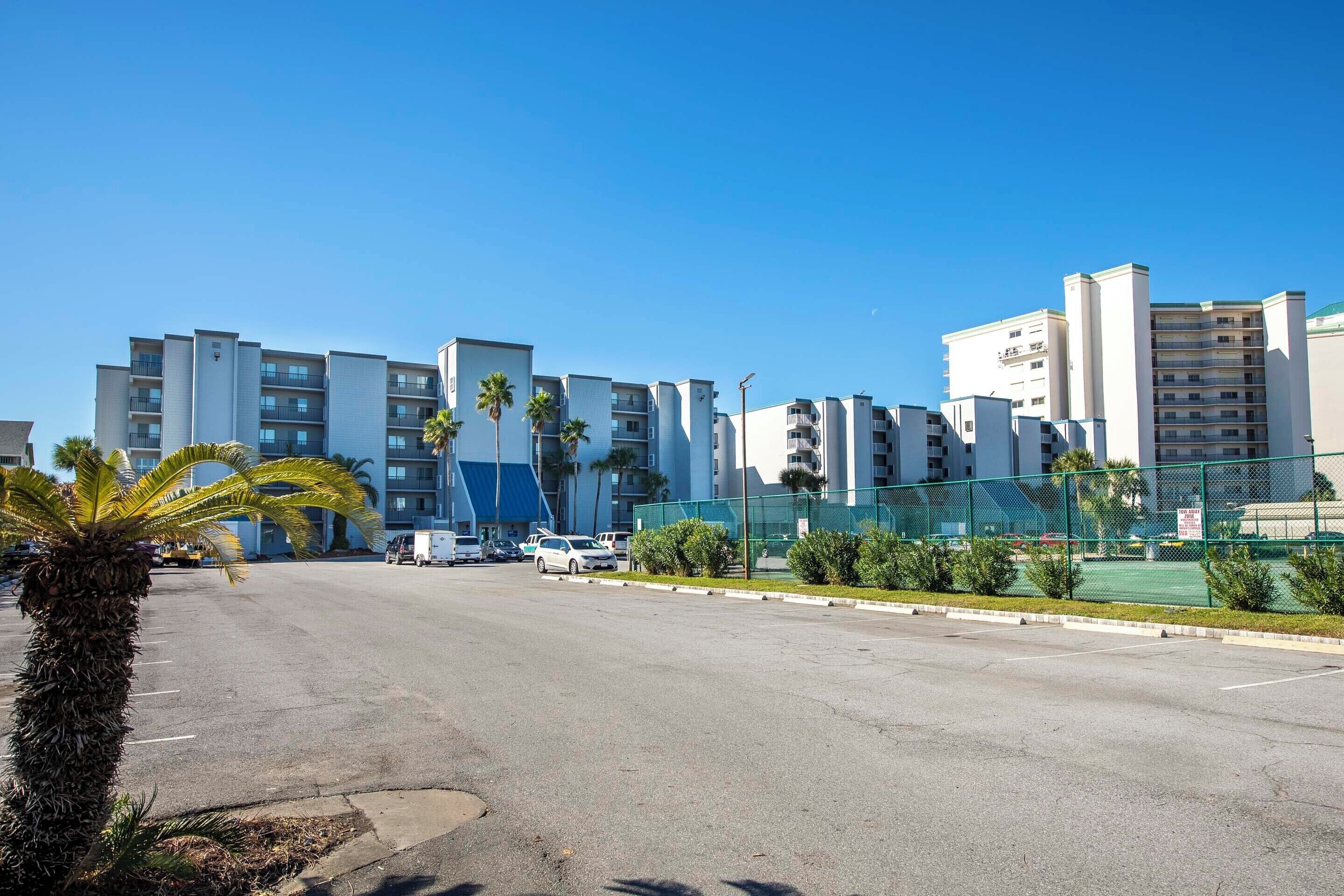 A multi-story parking lot with a clear sky.