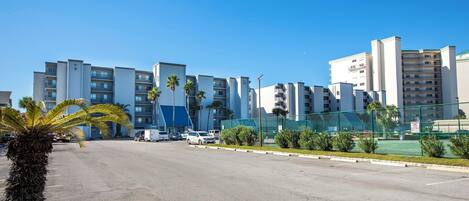 A multi-story parking lot with a clear sky.