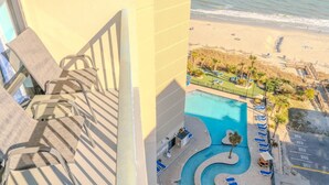 A pool with a circular design, a beach view, and a staircase leading to a balcony. - Sand Dunes 1246 (Myrtle Beach)