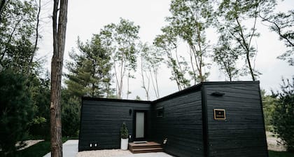 Luxurious mirrored cabin nestled on the Woods & Co Weddings + Events property for the ultimate getaway