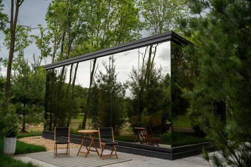 Luxurious mirrored cabin nestled on the Woods & Co Weddings + Events property for the ultimate getaway
