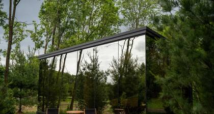 Luxurious mirrored cabin nestled on the Woods & Co Weddings + Events property for the ultimate getaway