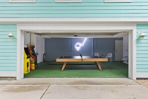 Enjoy a game of pool in this garage with a pool table and comfortable seating.