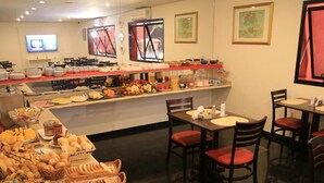 A buffet area with various food items and seating arrangements.