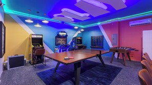 A room with a ping pong table, foosball table, and arcade games. - Sleeps 18! Family Retreat w/ Game Room, Pool, Resort Access Shadow Mountain (Davenport)