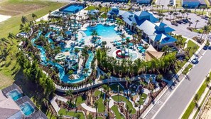 An aerial view of a resort with multiple swimming pools, palm trees, and a parking area. - Sleeps 26! Resort Home w/ On-site Waterpark, Pool Flamingo Grove by Avantstay (Davenport)