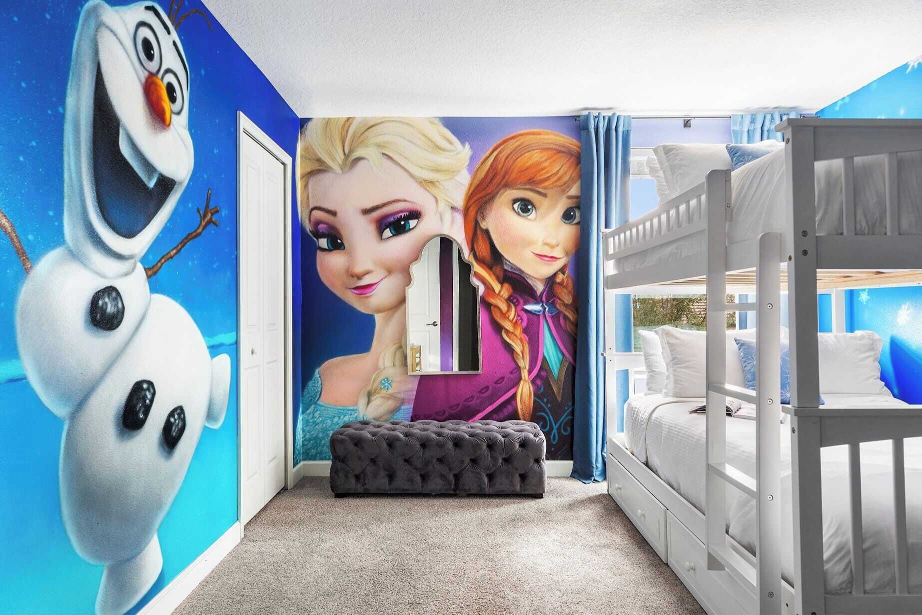 A child's bedroom with a bunk bed, a mural of animated characters, and a snowman decoration.
