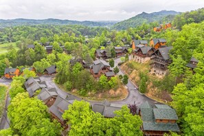 A resort with multiple cabins, surrounded by lush greenery and hills. - Summit View Way by Avantstay Resort Cabin w/ Hot Tub, Pool Table, Deck Views (Sevierville)
