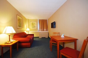 King Suite W Living Room | Living area | 32-inch TV with cable channels - St. Lawrence Hotel  (Massena)