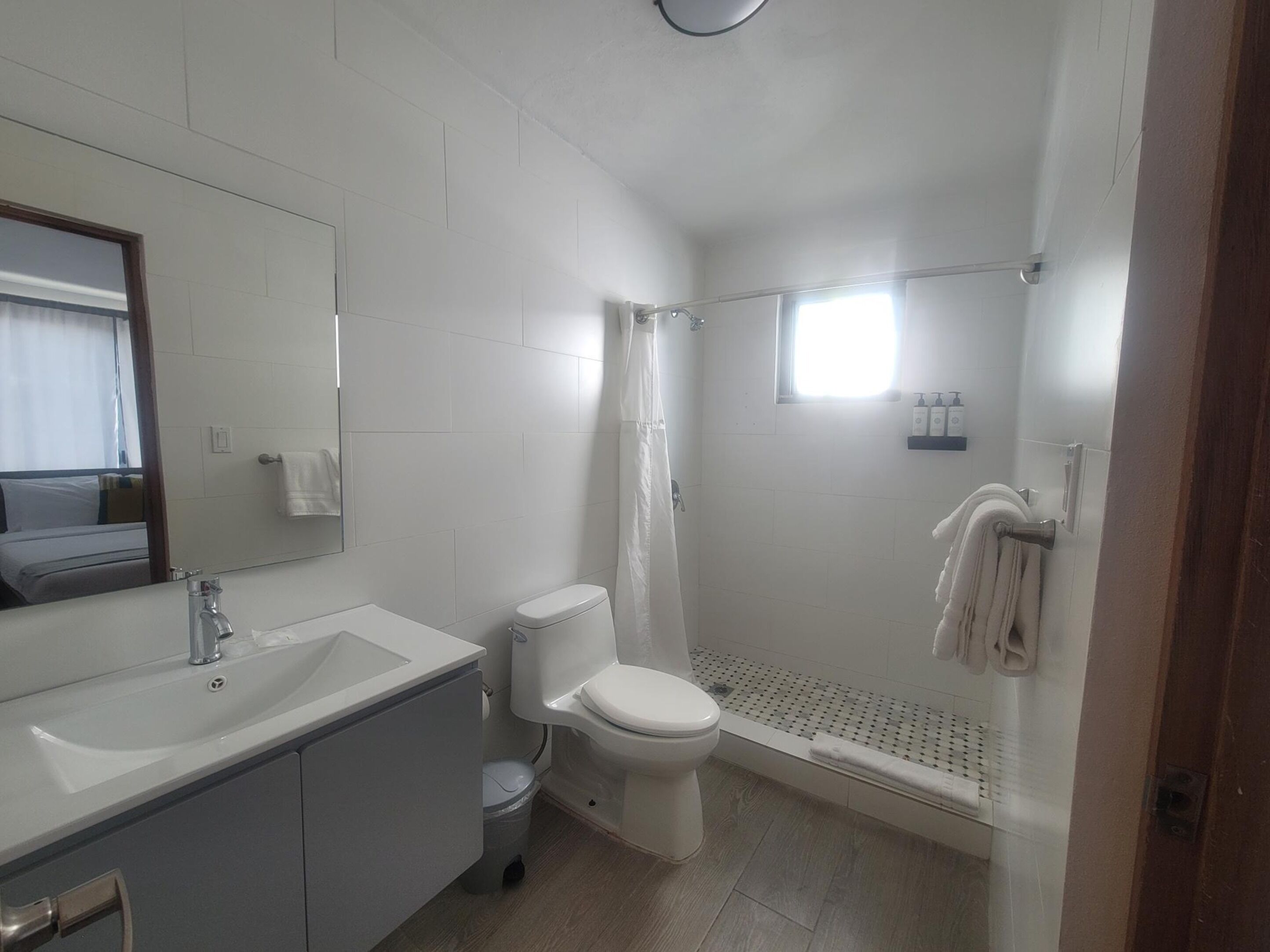 A modern bathroom with a sink, toilet, and shower.