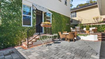 A patio with outdoor furniture and a hanging planter.
