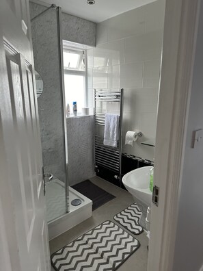 Shower, hair dryer, towels, toilet paper