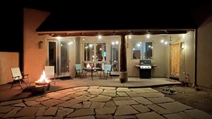 An outdoor patio area with a fire pit, seating, and a grill. - Quiet Retreat w/ Jacuzzi Tub and Fire Pit in Beautiful Prescott! (Prescott)
