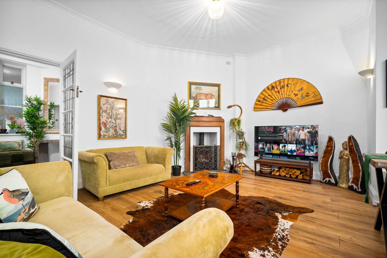 A living room with a sofa, coffee table, and a fireplace.
